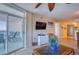 Living room featuring sliding glass doors to the balcony with views and a TV above a white console at 1903 S Ocean Blvd. # 701, North Myrtle Beach, SC 29582