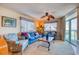 Bright living area with sofas, a leafy ceiling fan, and a sliding door to the balcony with ocean views at 1903 S Ocean Blvd. # 701, North Myrtle Beach, SC 29582