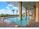 Beautiful outdoor pool with palm trees, lounge chairs, and ocean views at 1903 S Ocean Blvd. # 701, North Myrtle Beach, SC 29582