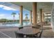 Beautiful outdoor pool with tables and chairs in a covered sitting area and palm trees, offering a relaxing retreat at 1903 S Ocean Blvd. # 701, North Myrtle Beach, SC 29582