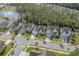 An aerial view of a cozy neighborhood featuring well-maintained homes and mature trees near a serene lake at 2122 Silver Spring Ln., Myrtle Beach, SC 29577