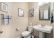 Clean powder room featuring a pedestal sink, artwork, and modern fixtures at 2122 Silver Spring Ln., Myrtle Beach, SC 29577