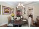 Elegant dining room featuring a chandelier, a dark wood table, and sophisticated decor for Gathering gatherings at 2122 Silver Spring Ln., Myrtle Beach, SC 29577