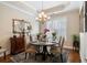 Cozy dining room featuring a round table, elegant chandelier, and stylish decor at 2122 Silver Spring Ln., Myrtle Beach, SC 29577