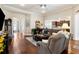 Cozy living room with hardwood floors, comfortable seating, and an open layout connecting to the kitchen at 2122 Silver Spring Ln., Myrtle Beach, SC 29577