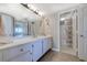 Clean and bright bathroom showcasing a vanity with white cabinets, a large mirror, and a view of the shower at 2307 S Ocean Blvd. # 5A, North Myrtle Beach, SC 29582