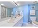 Bright bathroom featuring a white vanity, ample counter space, and coastal-themed decor at 2307 S Ocean Blvd. # 5A, North Myrtle Beach, SC 29582