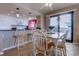 Dining area with white chairs and a wooden table near the kitchen and with access to the balcony at 2307 S Ocean Blvd. # 5A, North Myrtle Beach, SC 29582