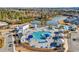 Aerial view of the community pool area with cabanas and a playground surrounded by lush greenery at 235 Calhoun Falls Dr., Myrtle Beach, SC 29579