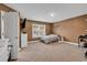 Cozy bedroom with warm tones, carpet flooring, and a bright window enhancing the room's ambiance at 235 Calhoun Falls Dr., Myrtle Beach, SC 29579