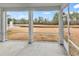 Screened-in porch with a view of the grassy backyard and a serene pond featuring a fountain at 235 Calhoun Falls Dr., Myrtle Beach, SC 29579