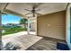 Covered back patio featuring a ceiling fan and views of the lake at 2381 Tidewatch Way, North Myrtle Beach, SC 29582