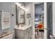 Well-lit bathroom with a gray vanity, framed mirror, and a glimpse into the bedroom at 2381 Tidewatch Way, North Myrtle Beach, SC 29582