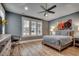 Bedroom with tray ceiling, ceiling fan, large shuttered windows, and neutral decor at 2381 Tidewatch Way, North Myrtle Beach, SC 29582