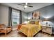 Cozy bedroom features a bright yellow quilt, decorative pillows, and a ceiling fan at 2381 Tidewatch Way, North Myrtle Beach, SC 29582