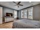 Bedroom featuring a neutral color palette, large dresser, ceiling fan, and shuttered windows at 2381 Tidewatch Way, North Myrtle Beach, SC 29582