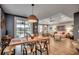 Dining room with a view of the lake through sliding glass doors, stylish light fixture, and view into living room at 2381 Tidewatch Way, North Myrtle Beach, SC 29582