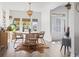 Bright dining room featuring a round table, four chairs, modern decor, and hardwood floors at 2408 Blue Crane Circle, Myrtle Beach, SC 29577