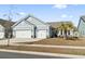 Charming single-Gathering home featuring a two-car garage, light blue siding, and well-manicured lawn at 2408 Blue Crane Circle, Myrtle Beach, SC 29577