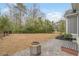 Spacious backyard with a stone patio, fire pit, and a black metal fence at 2409 Silkgrass Ln., Myrtle Beach, SC 29579