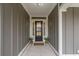 Elegant front door with glass panels flanked by potted plants, creating a welcoming entrance at 2409 Silkgrass Ln., Myrtle Beach, SC 29579