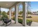 Inviting front porch with rocking chairs overlooking a landscaped lawn at 2409 Silkgrass Ln., Myrtle Beach, SC 29579