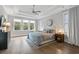 Serene bedroom with large windows, tray ceilings, and hardwood floors for ultimate relaxation at 2409 Silkgrass Ln., Myrtle Beach, SC 29579