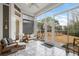 Bright sunroom with patterned tile flooring, comfortable seating, and large glass windows to the yard at 2409 Silkgrass Ln., Myrtle Beach, SC 29579