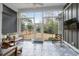 Bright sunroom with patterned tile flooring, comfortable seating, and large glass windows to the backyard at 2409 Silkgrass Ln., Myrtle Beach, SC 29579