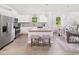 Well-lit kitchen with white cabinets, stainless steel appliances, and breakfast bar at 2538 Watershed Way, North Myrtle Beach, SC 29568