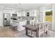 Modern kitchen with stainless steel appliances, center island, and adjacent dining area at 2538 Watershed Way, North Myrtle Beach, SC 29568