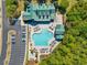 Aerial view of the community pool, featuring ample seating, parking, and lush landscaping at 2557 Pete Dye Dr. # 702, North Myrtle Beach, SC 29582