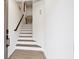 Inviting entryway featuring a bright staircase with modern wood railings and durable wood-look flooring at 2557 Pete Dye Dr. # 702, North Myrtle Beach, SC 29582