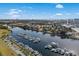 Aerial view of a marina filled with boats on the calm waterway, with the city skyline in the background at 2557 Pete Dye Dr. # 702, North Myrtle Beach, SC 29582