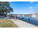 Scenic waterfront walkway with benches, a wood and metal fence, and boats docked on the beautiful waterway at 2557 Pete Dye Dr. # 702, North Myrtle Beach, SC 29582