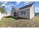 Exterior view of a home showcasing a covered patio, neat vinyl siding, and green lawn at 2960 Tigers Eye Rd., Little River, SC 29566