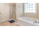 Bright bathroom featuring a soaking tub, shower, and a large window that provides plenty of natural light at 2960 Tigers Eye Rd., Little River, SC 29566