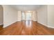 Spacious living room featuring hardwood floors, neutral paint, and bright natural light at 2960 Tigers Eye Rd., Little River, SC 29566