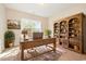 Cozy home office with an antique desk, built-in bookcase, and plush rug at 2960 Tigers Eye Rd., Little River, SC 29566