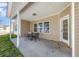 Covered patio with outdoor dining set, offering a relaxing space for entertaining and enjoying the outdoors at 2960 Tigers Eye Rd., Little River, SC 29566