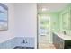 Modern bathroom adjacent to main bedroom with tub and vanity at 308 24Th Ave. N, North Myrtle Beach, SC 29582
