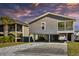 Beautiful elevated beach home with modern siding, covered parking, and brick paved driveway at 308 24Th Ave. N, North Myrtle Beach, SC 29582