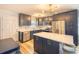 Modern kitchen featuring navy cabinets, stainless appliances, an island with breakfast bar, and quartz countertops at 308 24Th Ave. N, North Myrtle Beach, SC 29582