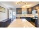 Modern kitchen with navy cabinets, stainless steel appliances, and an island with quartz countertops at 308 24Th Ave. N, North Myrtle Beach, SC 29582