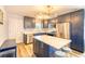 Modern kitchen featuring navy cabinets, stainless appliances, an island with breakfast bar, and quartz countertops at 308 24Th Ave. N, North Myrtle Beach, SC 29582
