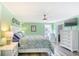 Bright main bedroom features a queen bed, ceiling fan, and white furniture at 308 24Th Ave. N, North Myrtle Beach, SC 29582