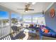 Cozy screened porch features comfortable seating, ceiling fan, and neighborhood views at 308 24Th Ave. N, North Myrtle Beach, SC 29582