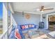 Relaxing covered porch with comfortable seating, ceiling fan, and neighborhood views at 308 24Th Ave. N, North Myrtle Beach, SC 29582