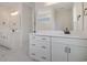 Bright bathroom featuring double vanity with white cabinets, black hardware, and marble tile flooring at 319 Crossing Ct., Myrtle Beach, SC 29588