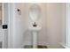 Powder room with pedestal sink, round mirror, and modern fixtures at 319 Crossing Ct., Myrtle Beach, SC 29588